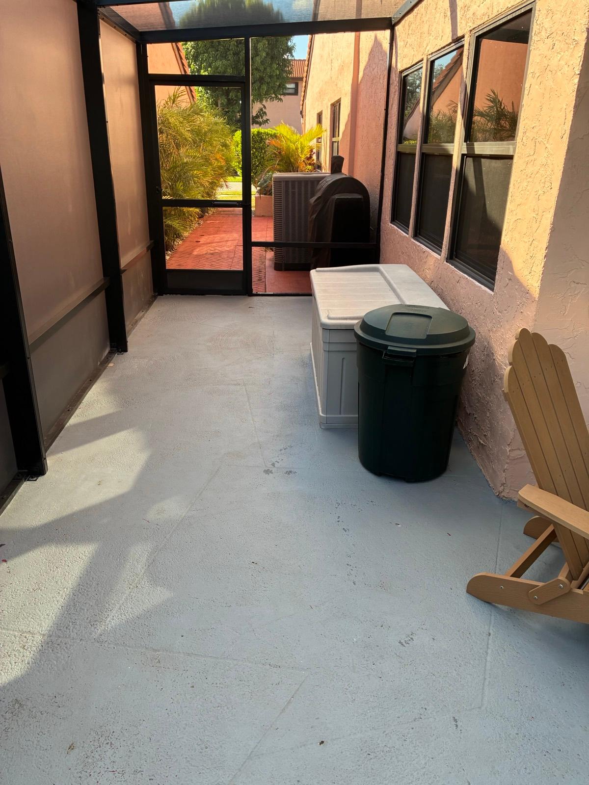 Decorative epoxy patio floor coating under a pergola installed by Resin Masters in Palm Beach, FL