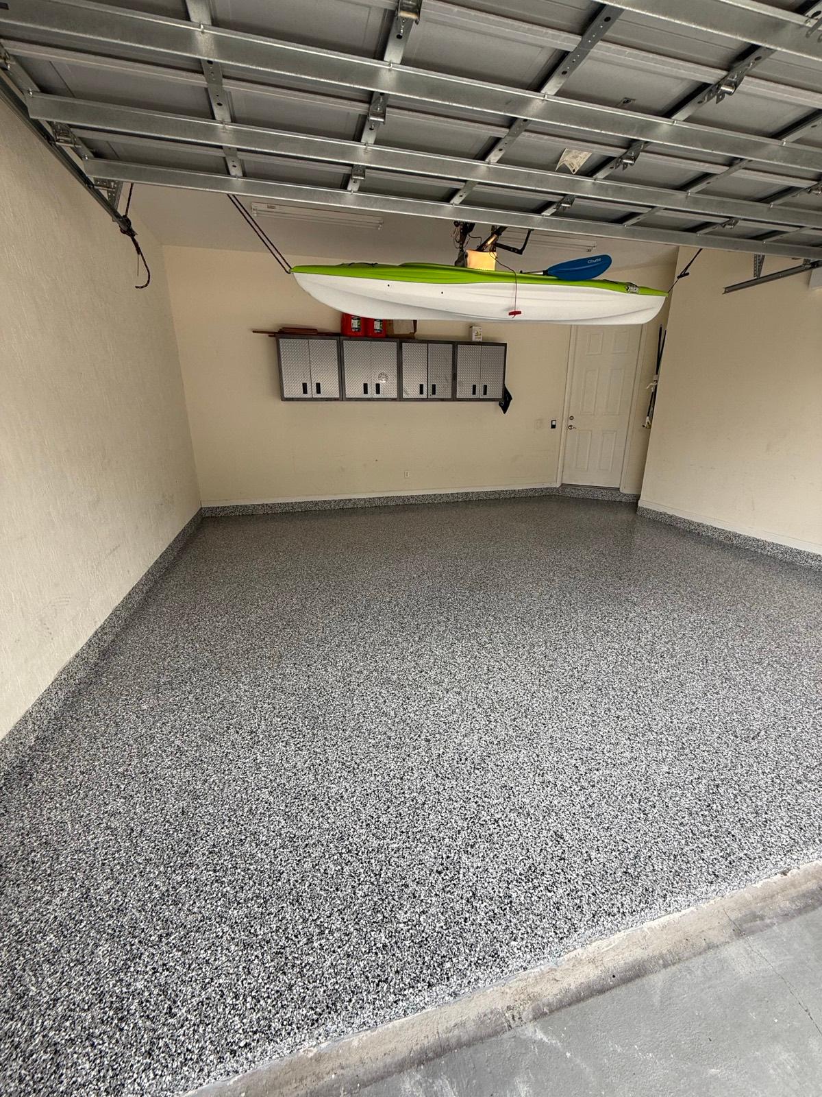 Gray full flake epoxy garage floor after installation by Resin Masters in Boca Raton, FL
