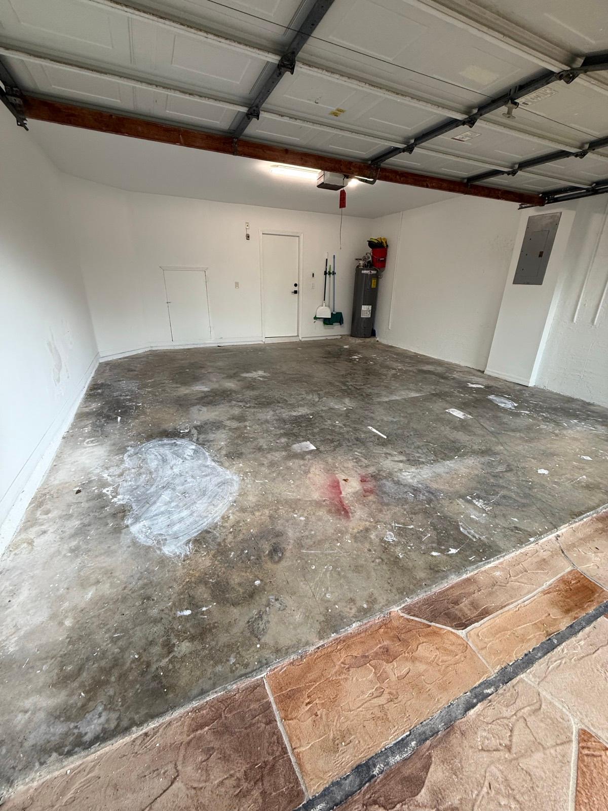 Old damaged concrete garage floor before epoxy resurfacing in Delray Beach, FL