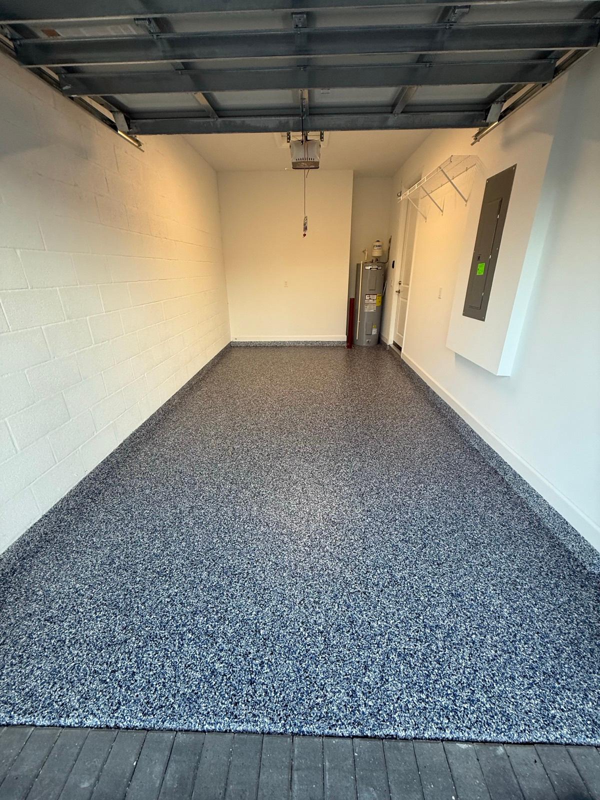 Wide-bay full flake epoxy garage floor with speckled gray finish installed by Resin Masters in Coral Springs, FL