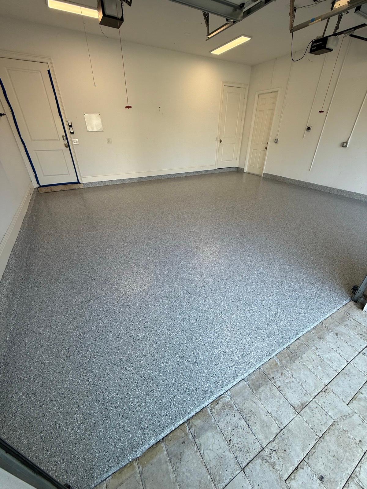 Decorative gray flake epoxy garage floor coating installed by Resin Masters in Wellington, FL
