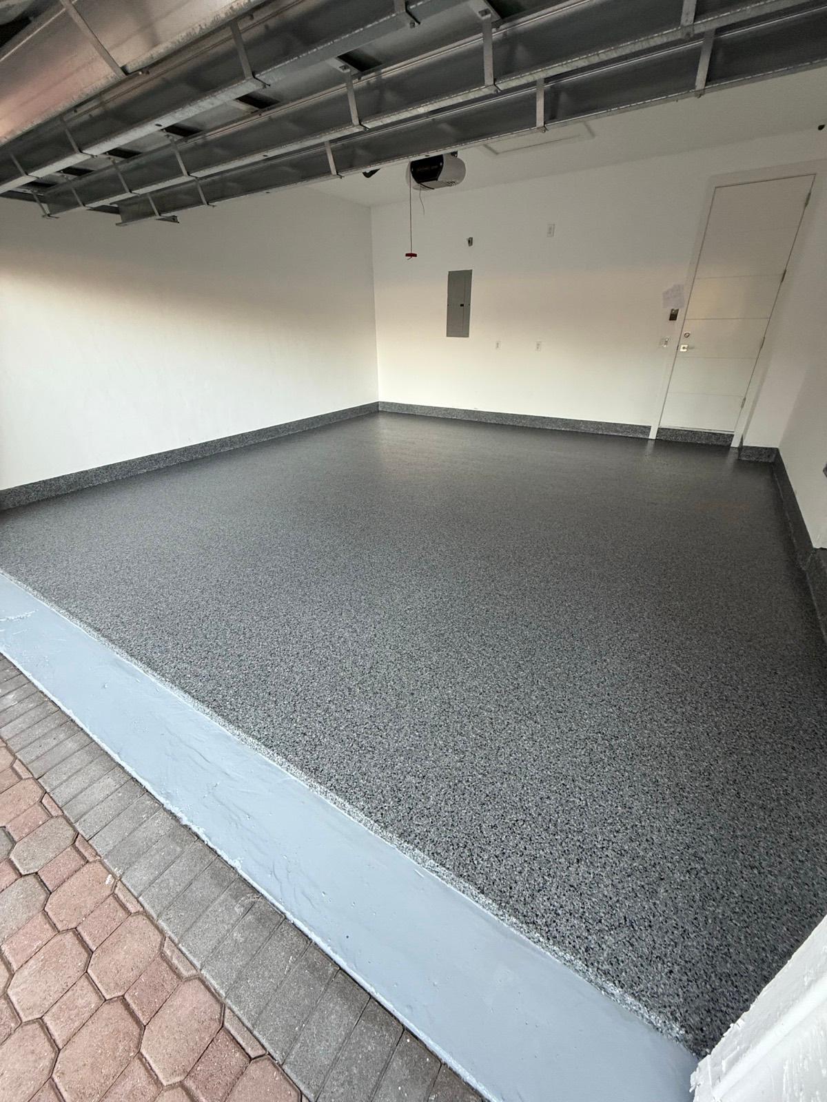 Full flake epoxy garage floor with polyaspartic topcoat installed by Resin Masters in Deerfield Beach, FL