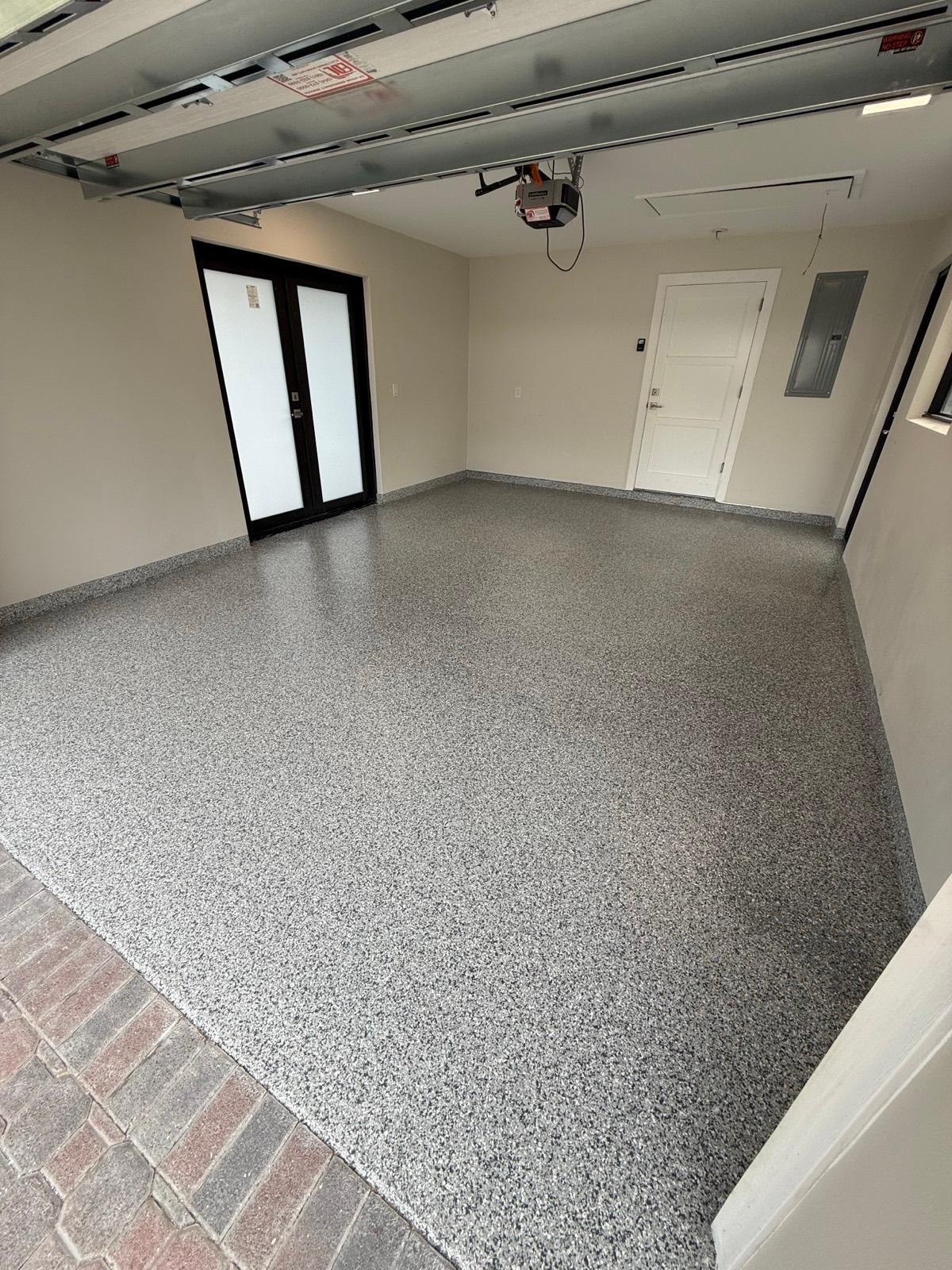 Gray full flake epoxy garage floor with step installed by Resin Masters in Jupiter, FL