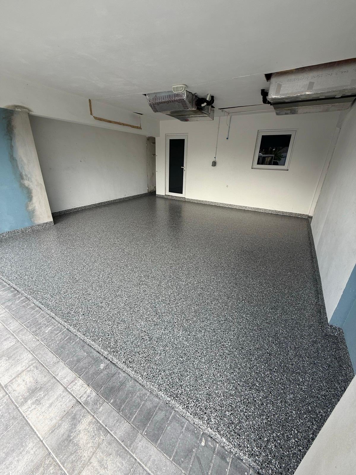 Seamless flake epoxy garage floor installed by Resin Masters in Coconut Creek, FL