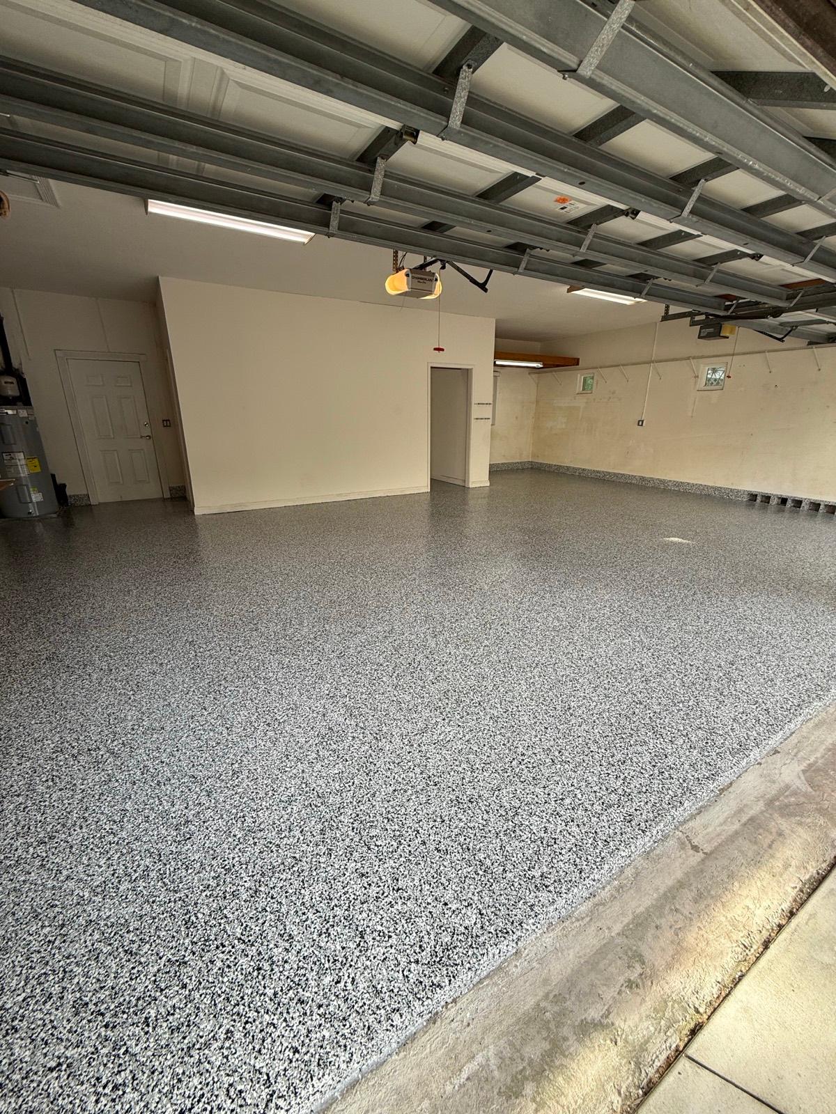 Full flake epoxy garage floor finished by Resin Masters installed by Resin Masters in Weston, FL