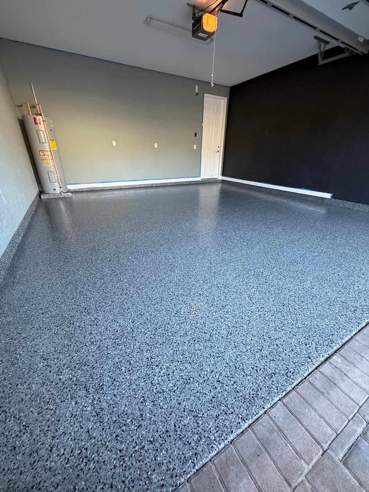 Gray decorative flake epoxy garage floor installed by Resin Masters in Plantation, FL