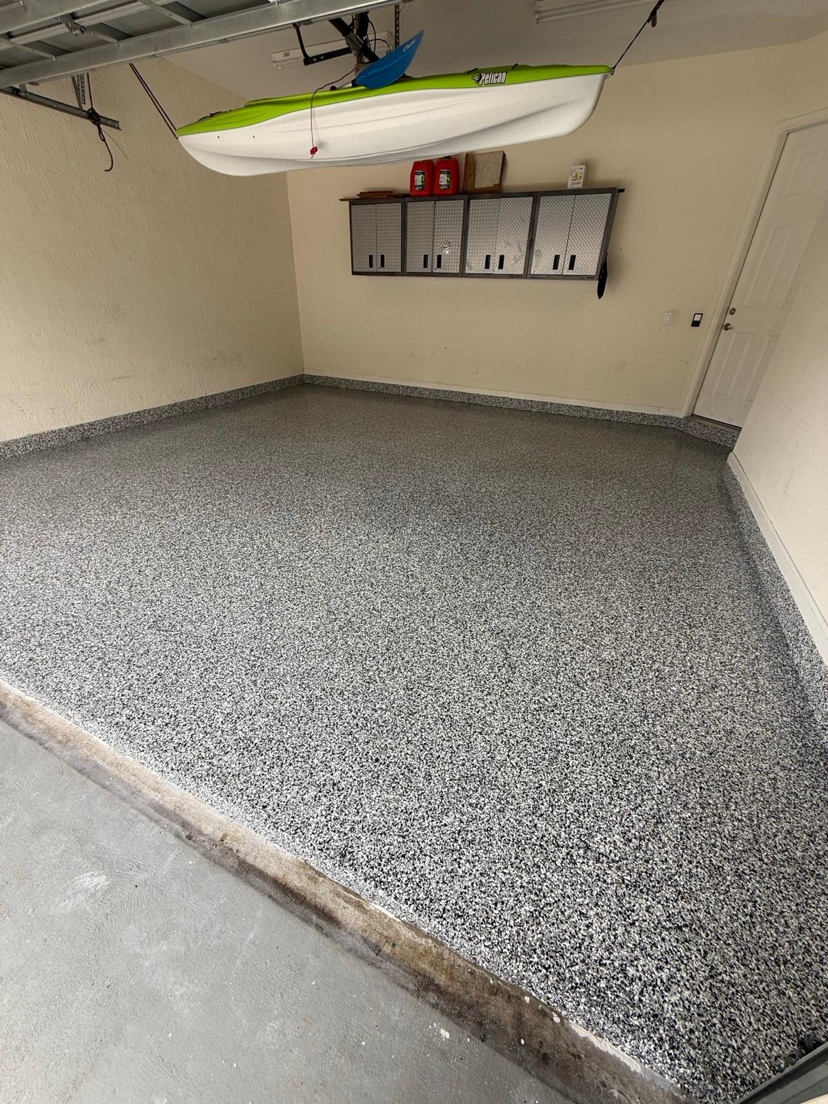 Full flake epoxy garage floor with clean modern finish installed by Resin Masters in Lake Worth, FL