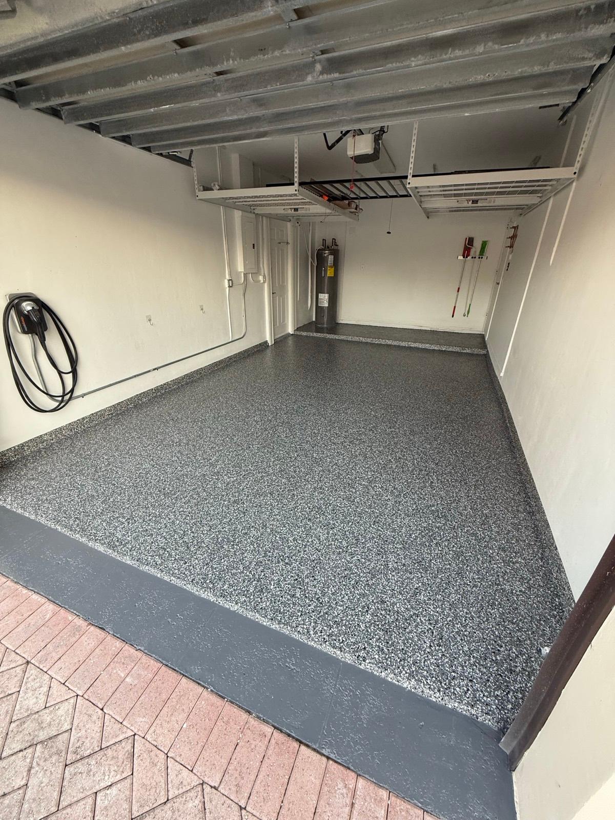Tan and beige flake epoxy garage floor after installation by Resin Masters in Parkland, FL